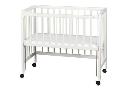 White baby crib with wheels and slatted sides on a white background.