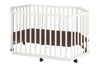 White baby crib with a brown mattress and wheels on a white background.