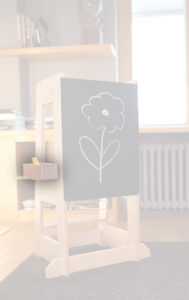 Wooden easel with chalk drawing of a flower in a cozy room.