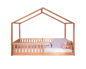 Wooden house-shaped children's bed with pillows and stuffed toys on mattress.