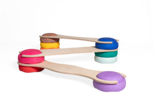 Colorful balancing boards with cushioned bases in red, purple, blue, and yellow.
